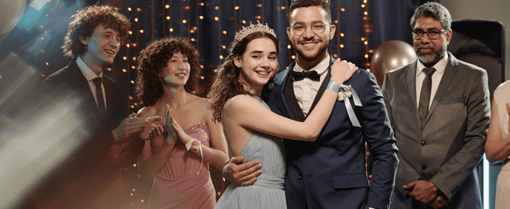 Prom king and queen pose for a picture after being crowned